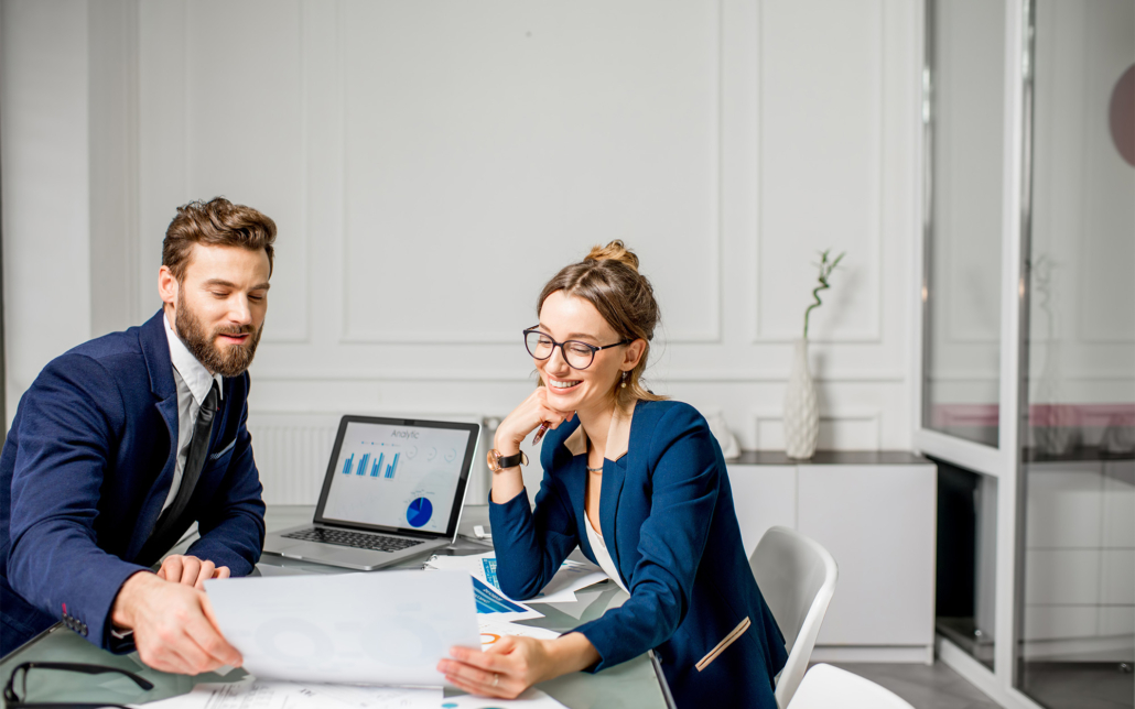 Accounting professionals analyzing financial data on a laptop screen